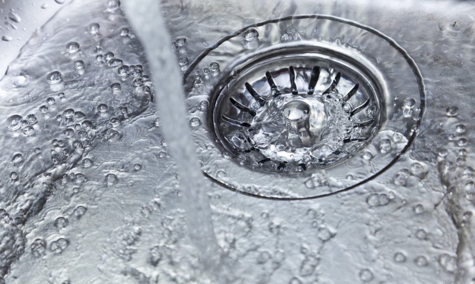 Plumber working on a drain
